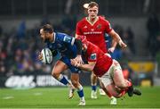 25 November 2023; Jamison Gibson-Park of Leinster is tackled by John Hodnett of Munster during the United Rugby Championship match between Leinster and Munster at the Aviva Stadium in Dublin. Photo by Harry Murphy/Sportsfile