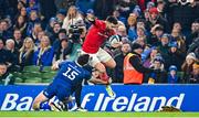 25 November 2023; Conor Murray of Munster evades the tackle of Hugo Keenan of Leinster during the United Rugby Championship match between Leinster and Munster at the Aviva Stadium in Dublin. Photo by Tyler Miller/Sportsfile