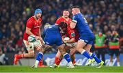 25 November 2023; Diarmuid Barron of Munster is tackled by Andrew Porter of Leinster, left, and Rónan Kelleher during the United Rugby Championship match between Leinster and Munster at the Aviva Stadium in Dublin. Photo by Tyler Miller/Sportsfile