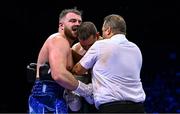 25 November 2023; Thomas Carty, left, and Dan Garber are seperated by referee Paul McCullagh during their heavyweight bout at the 3Arena in Dublin. Photo by Stephen McCarthy/Sportsfile