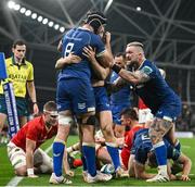 25 November 2023; Jordan Larmour of Leinster, centre, is congratulated by team mates Caelan Doris, left, and Andrew Porter after scoring their third try  during the United Rugby Championship match between Leinster and Munster at the Aviva Stadium in Dublin. Photo by David Fitzgerald/Sportsfile