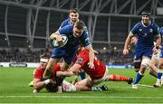 25 November 2023; Jordan Larmour of Leinster scores his side's third try despite Alex Kendellen, left, and Jean Kleyn of Munster during the United Rugby Championship match between Leinster and Munster at the Aviva Stadium in Dublin. Photo by David Fitzgerald/Sportsfile