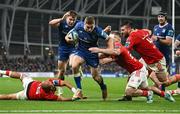 25 November 2023; Jordan Larmour of Leinster on his way to scoring his side's third try despite Simon Zebo and Alex Kendellen of Munster, right, during the United Rugby Championship match between Leinster and Munster at the Aviva Stadium in Dublin. Photo by David Fitzgerald/Sportsfile