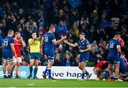 25 November 2023; Leinster players including Ross Molony, centre left, and Jordan Larmour, centre right, celebrate as referee Chris Busby blows the final whistle during the United Rugby Championship match between Leinster and Munster at the Aviva Stadium in Dublin. Photo by Sam Barnes/Sportsfile
