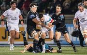 25 November 2023; John Cooney of Ulster is tackled by Rory Darge, left, and Sean Kennedy of Glasgow Warriors during the United Rugby Championship match between Glasgow Warriors and Ulster at Scotstoun Stadium in Glasgow, Scotland. Photo by Paul Devlin/Sportsfile