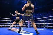 25 November 2023; Katie Taylor, left, is knocked down by Chantelle Cameron in the opening round of their undisputed super lightweight championship bout at the 3Arena in Dublin. Photo by Stephen McCarthy/Sportsfile