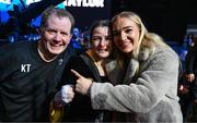 25 November 2023; Katie Taylor celebrates with manager Brian Peters, left, and boxer Amy Broadhurst, right, after defeating Chantelle Cameron in her undisputed super lightweight championship fight at the 3Arena in Dublin. Photo by Stephen McCarthy/Sportsfile