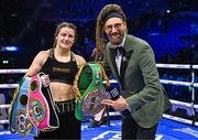 25 November 2023; Katie Taylor with MC David Diamante after defeating Chantelle Cameron in their undisputed super lightweight championship fight at the 3Arena in Dublin. Photo by Stephen McCarthy/Sportsfile