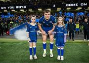 25 November 2023; Leinster co-captain Garry Ringrose walks out with matchday mascots Eabha Hurley and Katie Murphy before the United Rugby Championship match between Leinster and Munster at the Aviva Stadium in Dublin. Photo by Harry Murphy/Sportsfile