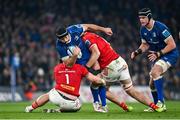 25 November 2023; Caelan Doris of Leinster is tackled by Jeremy Loughman, left, and Tom Ahern of Munster during the United Rugby Championship match between Leinster and Munster at the Aviva Stadium in Dublin. Photo by Sam Barnes/Sportsfile