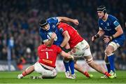 25 November 2023; Caelan Doris of Leinster is tackled by Jeremy Loughman, left, and Tom Ahern of Munster during the United Rugby Championship match between Leinster and Munster at the Aviva Stadium in Dublin. Photo by Sam Barnes/Sportsfile