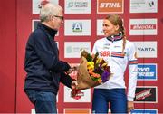 26 November 2023; Sport Ireland Chief Operations Officer, Michael Murray presents the second place flowers to Cat Ferguson of Great Britain after the Womens Junior race during Round 5 of the UCI Cyclocross World Cup at the Sport Ireland Campus in Dublin. Photo by David Fitzgerald/Sportsfile