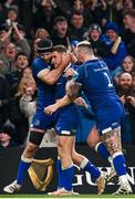 25 November 2023; Jordan Larmour of Leinster, centre, celebrates with teammates Caelan Doris and Andrew Porter after scoring his side's third try during the United Rugby Championship match between Leinster and Munster at the Aviva Stadium in Dublin. Photo by Harry Murphy/Sportsfile