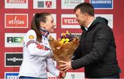 26 November 2023; Cycling Ireland Chief Executive Officer, James Quilligan presents the third place flowers to Imogen Wolff of Great Britain after the Womens Junior race during Round 5 of the UCI Cyclocross World Cup at the Sport Ireland Campus in Dublin. Photo by David Fitzgerald/Sportsfile