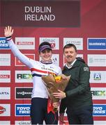 26 November 2023; Cycling Ireland Chief Executive Officer, James Quilligan, presents the third place flowers to Zoe Backstedt of Great Britain after the Elite Womens race during Round 5 of the UCI Cyclocross World Cup at the Sport Ireland Campus in Dublin. Photo by David Fitzgerald/Sportsfile