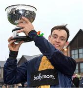 26 November 2023; JJ Slevin with the John Durkan Memorial Cup after winning the John Durkan Memorial Punchestown Steeplechase with Fastorslow on day two of the Punchestown Winter Festival at Punchestown Racecourse in Kildare. Photo by Matt Browne/Sportsfile