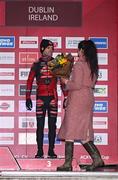 26 November 2023; Ambassador of the Kingdom of Belgium to Ireland Karen Van Vlierberge presents the third place flowers to Eli Iserbyt of Belgium after the Elite Mens race during Round 5 of the UCI Cyclocross World Cup at the Sport Ireland Campus in Dublin. Photo by David Fitzgerald/Sportsfile