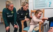 27 Novmeber 2023; Republic of Ireland's Erin McLaughlin, left, and Denise O'Sullivan, with Duvheasa Finneran, age 2, from Toberconor, Roscommon, during a visit to Cappagh Kids and The National Orthopaedic Hospital Cappagh in Dublin to launch the Cappagh Hospital Foundation Christmas Appeal and their fundraising ambassador Boney Maloney. Photo by Ramsey Cardy/Sportsfile