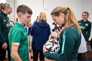 27 Novmeber 2023; Republic of Ireland's Kyra Carusa signs a football for Tadhg Mallon during a visit to Cappagh Kids and The National Orthopaedic Hospital Cappagh in Dublin to launch the Cappagh Hospital Foundation Christmas Appeal and their fundraising ambassador Boney Maloney. Photo by Stephen McCarthy/Sportsfile