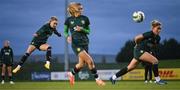 28 November 2023; Izzy Atkinson gets her shot away past Jamie Finn and Jessie Stapleton, right, during a Republic of Ireland women training session at the FAI National Training Centre in Abbotstown, Dublin. Photo by Stephen McCarthy/Sportsfile