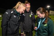 28 November 2023; Republic of Ireland's Louise Quinn, left, and Caitlin Hayes with Reeva Merriman of the Ireland women's cerebral palsy team, who were recently crowned champions of the International Federation of CP Football Nations League for 2023, at the FAI National Training Centre in Abbotstown, Dublin. Photo by Stephen McCarthy/Sportsfile