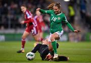 1 December 2023; Kyra Carusa of Republic of Ireland evades the tackle of Hungary goalkeeper Réka Szocs during the UEFA Women's Nations League B match between Republic of Ireland and Hungary at Tallaght Stadium in Dublin. Photo by Seb Daly/Sportsfile