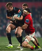 1 December 2023; Stafford McDowall of Glasgow Warriors is tackled by Tom Ahern of Munster during the United Rugby Championship match between Munster and Glasgow Warriors at Musgrave Park in Cork. Photo by Eóin Noonan/Sportsfile