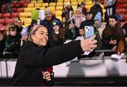 1 December 2023; Denise O'Sullivan of Republic of Ireland takes a photograph with supporters after her side's victory in the UEFA Women's Nations League B match between Republic of Ireland and Hungary at Tallaght Stadium in Dublin. Photo by Seb Daly/Sportsfile