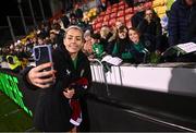 1 December 2023; Denise O'Sullivan of Republic of Ireland takes a photograph with supporters after her side's victory in the UEFA Women's Nations League B match between Republic of Ireland and Hungary at Tallaght Stadium in Dublin. Photo by Seb Daly/Sportsfile