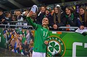 1 December 2023; Jamie Finn of Republic of Ireland takes a photograph with supporters after their side's victory in the UEFA Women's Nations League B match between Republic of Ireland and Hungary at Tallaght Stadium in Dublin. Photo by Ben McShane/Sportsfile