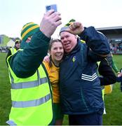 2 December 2023; Ballinamore Sean O'Heslins manager Barney Breen takes a selfie with Abbi Sweeney of Ballinamore Sean O'Heslins, centre, and a supporter after the Currentaccount.ie All-Ireland Ladies Intermediate Club Championship semi-final match between Ballinamore Sean O’Heslins of Leitrim and Steelstown Brian Ógs of Derry at Páirc Sheáin Ui Eislin, Ballinamore, Leitrim. Photo by Ben McShane/Sportsfile