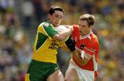 11 July 2004; Michael Hegarty, Donegal, is tackled by Kieran McGeeney, Armagh. Bank of Ireland Ulster Senior Football Championship Final, Armagh v Donegal, Croke Park, Dublin. Picture credit; Matt Browne / SPORTSFILE