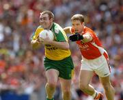 11 July 2004; John Gildea, Donegal, with blood on his face from a head wound, is tackled by Kieran McGeeney, Armagh. Bank of Ireland Ulster Senior Football Championship Final, Armagh v Donegal, Croke Park, Dublin. Picture credit; Matt Browne / SPORTSFILE