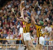11 July 2004; David Tierney, Galway, in action against Peter Barry and Richard Mullally, right, Kilkenny. Guinness Senior Hurling Championship Qualifier, Round 3, Galway v Kilkenny, Semple Stadium, Thurles, Co. Tipperary. Picture credit; Pat Murphy / SPORTSFILE