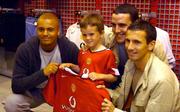 15 July 2004; Manchester United players Wes Brown, John O'Shea and Liam Miller with Cian O'Loughlin, age 4, from Finglas, at the launch of the new Manchester United home shirt for the 2004/2005 season, in Champion Sports, Jervis Street Shooping centre, Dublin. Picture credit; Brian Lawless / SPORTSFILE