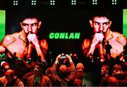 2 December 2023; A supporter takes a picture before the super-featherweight bout between Michael Conlan and Jordan Gill at the SSE Arena in Belfast. Photo by Ramsey Cardy/Sportsfile