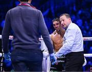 2 December 2023; Michael Conlan with referee Harold Foster after his super-featherweight bout against Jordan Gill at the SSE Arena in Belfast. Photo by Ramsey Cardy/Sportsfile