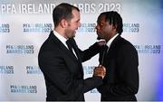 2 December 2023; PFA Ireland Men’s Premier Division Team of the Year 2023 medal recipient Jonathan Afolabi of Bohemians is congratulated by guest of honour John O'Shea, former Republic of Ireland international, during the PFA Ireland Awards 2023 at Anantara The Marker Dublin Hotel in Dublin. Photo by Stephen McCarthy/Sportsfile
