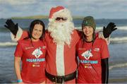 3 December 2023; Carol and Cora Lee, from from Portstewart, with Santa Claus at the Portrush Polar Plunge which saw participants get “Freezin’ for a Reason” to raise funds for Special Olympics Ireland athletes in an event sponsored by Gala Retail at Portrush East Strand Beach in Portrush, Antrim. Photo by Oliver McVeigh/Sportsfile