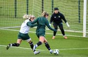 3 December 2023; Saoirse Noonan has a shot on goalkeeper Grace Moloney despite the tackle of Lily Agg during a Republic of Ireland women training session at the FAI National Training Centre in Abbotstown, Dublin. Photo by Stephen McCarthy/Sportsfile