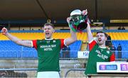 3 December 2023; St Brigid's joint-captains Mark Daly, left, and Paul McGrath lift the Shane McGettigan cup after their side's victory in the AIB Connacht GAA Football Senior Club Championship final between St Brigid's, Roscommon, and Corofin, Galway, at Dr Hyde Park in Roscommon. Photo by Piaras Ó Mídheach/Sportsfile