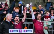 3 December 2023; Ruairí Óg captain Neil McManus, right, with daughter Aoibhinn, age 1, and vice-captain Ryan McCambridge lift the cup after the AIB Ulster GAA Hurling Senior Club Championship final match between Ruairi Óg, Antrim, and Slaughtneil, Derry, at Páirc Esler in Newry, Down. Photo by Ben McShane/Sportsfile