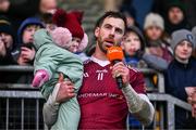 3 December 2023; Ruairí Óg captain Neil McManus with his daughter Aoibhinn, age 1, makes a speech after the AIB Ulster GAA Hurling Senior Club Championship final match between Ruairi Óg, Antrim, and Slaughtneil, Derry, at Páirc Esler in Newry, Down. Photo by Ben McShane/Sportsfile