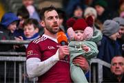 3 December 2023; Ruairí Óg captain Neil McManus with his daughter Aoibhinn, age 1, makes a speech after the AIB Ulster GAA Hurling Senior Club Championship final match between Ruairi Óg, Antrim, and Slaughtneil, Derry, at Páirc Esler in Newry, Down. Photo by Ben McShane/Sportsfile