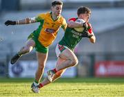 3 December 2023; Ben O'Connor of St Brigid's in action against Gavin Burke of Corofin during the AIB Connacht GAA Football Senior Club Championship final between St Brigid's, Roscommon, and Corofin, Galway, at Dr Hyde Park in Roscommon. Photo by Piaras Ó Mídheach/Sportsfile