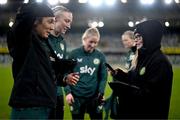 4 December 2023; STATSports analyst Claire Dunne with goalkeeper Grace Moloney, left, Louise Quinn and Sophie Whitehouse, centre, during a Republic of Ireland women training session at the National Football Stadium at Windsor Park in Belfast. Photo by Stephen McCarthy/Sportsfile