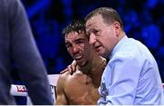 2 December 2023; Michael Conlan, with referee Howard Foster, after his super-featherweight bout against Jordan Gill at the SSE Arena in Belfast. Photo by Ramsey Cardy/Sportsfile