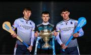 5 December 2023; Maynooth University hurler Billy Drennan, centre, and University of Limerick hurlers Gearóid O'Connor, left, and Colin Coughlan with the Fitzgibbon Cup before the draw for the Electric Ireland GAA Higher Education Championships at Croke Park in Dublin. Photo by Piaras Ó Mídheach/Sportsfile