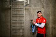 5 December 2023; University College Cork footballer Dylan Foley poses for a portrait with the Sigerson Cup before the draw for the Electric Ireland GAA Higher Education Championships at Croke Park in Dublin. Photo by Piaras Ó Mídheach/Sportsfile