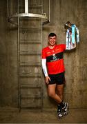 5 December 2023; University College Cork footballer Dylan Foley poses for a portrait with the Sigerson Cup before the draw for the Electric Ireland GAA Higher Education Championships at Croke Park in Dublin. Photo by Piaras Ó Mídheach/Sportsfile